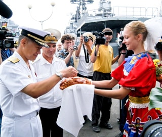 Officers from a visiting Japanese destroyer are greeted with traditional Russian bread and salt in 2007