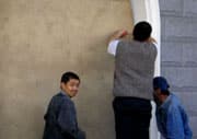 Kyrgyz boarding a window to a shop before the protests